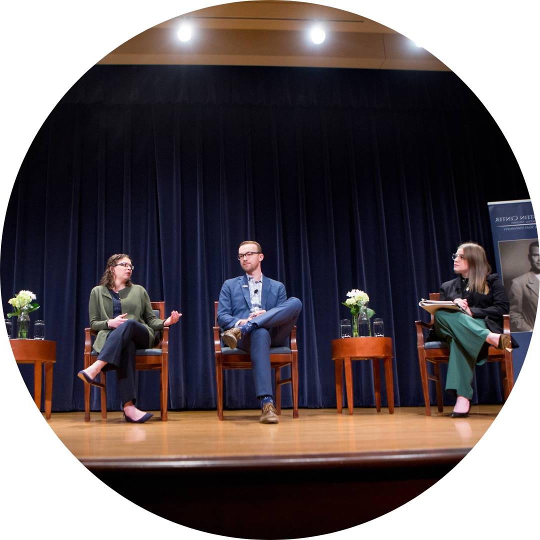 people on a panel on stage